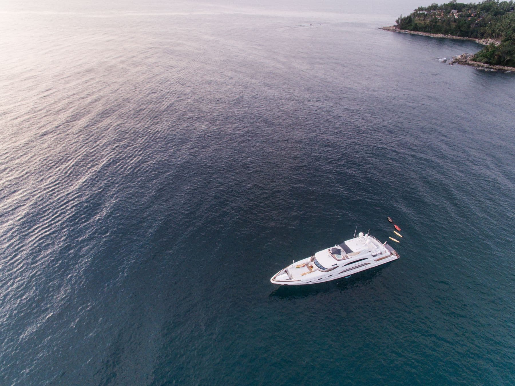 A superyacht at anchor off the Riviera coast.